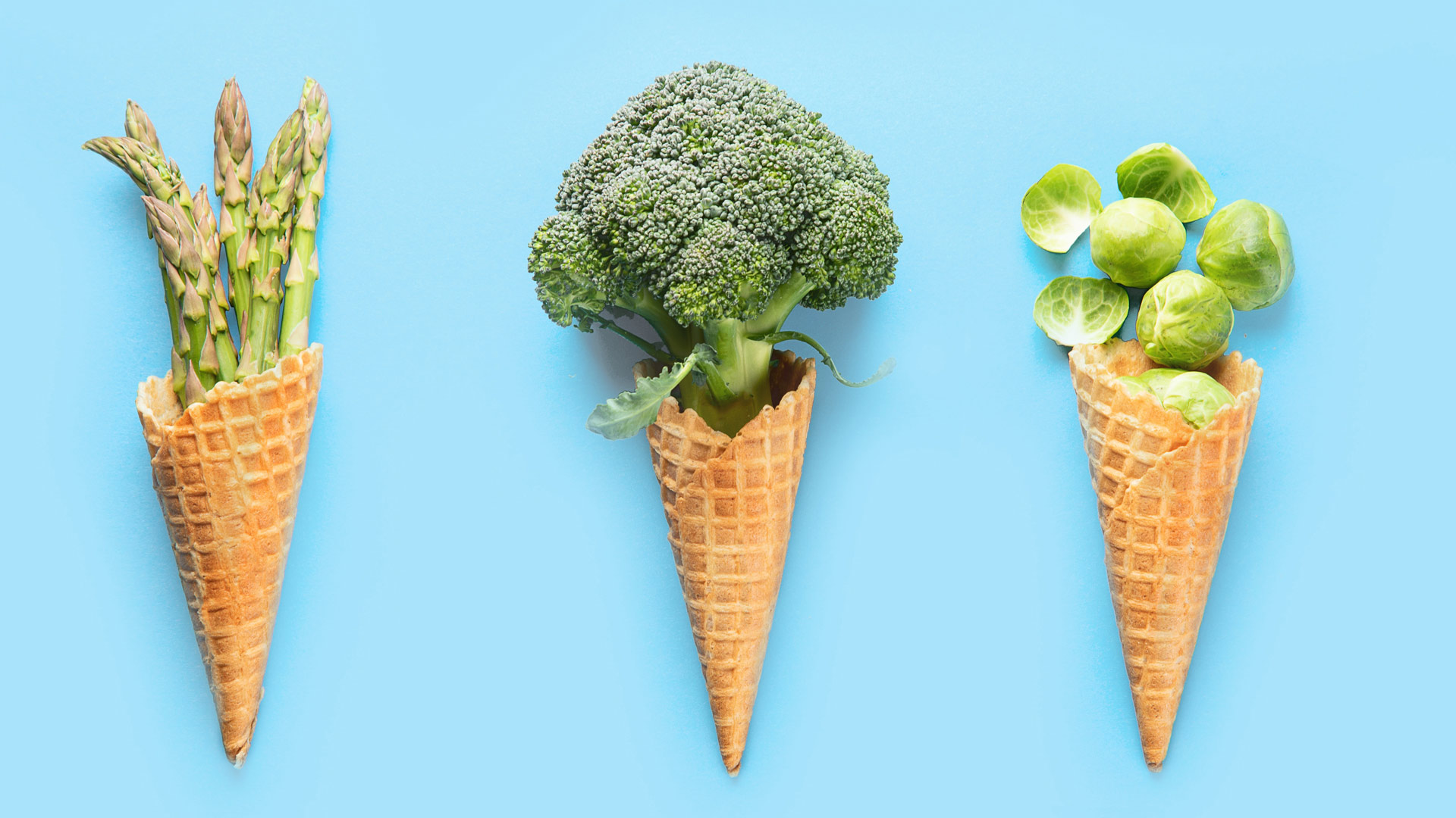 ice cream cones filled with asparagus, broccoli, and brussels sprouts