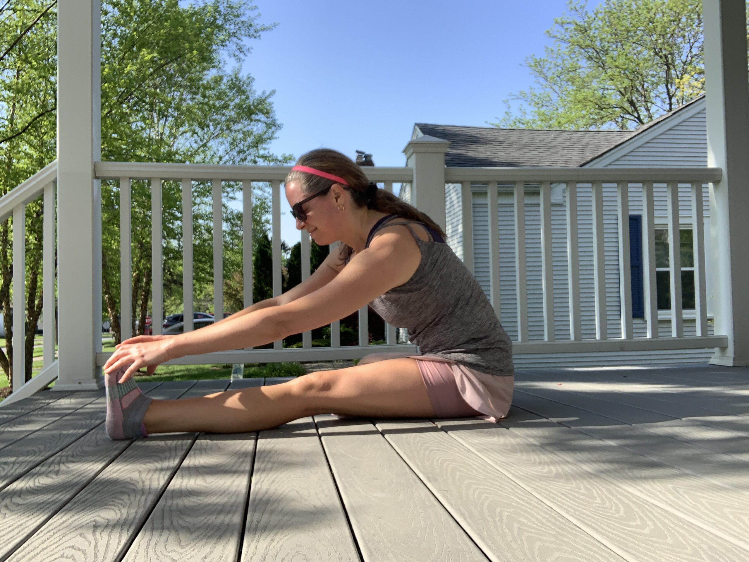 woman stretching on her front porch